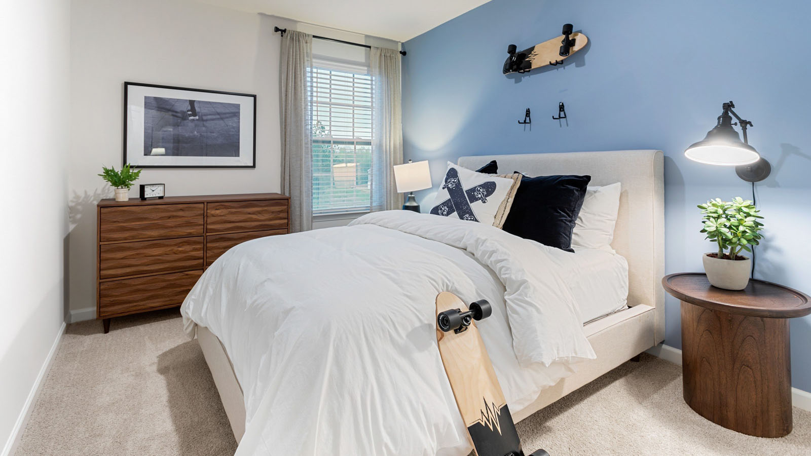 secondary bedroom with window and carpet
