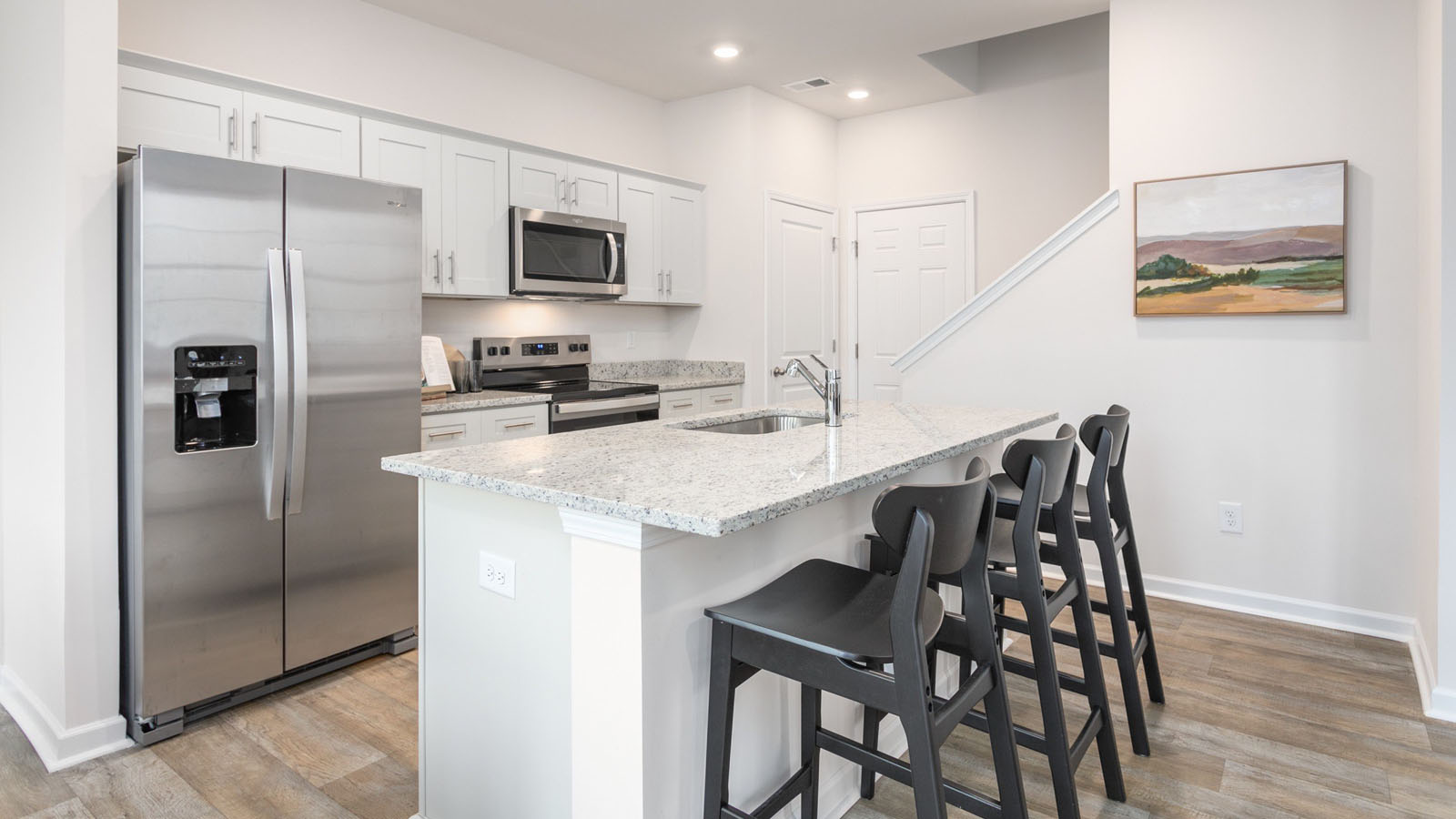 Dining/kitchen area with stainless steel appliances, and island, shaker style cabinets