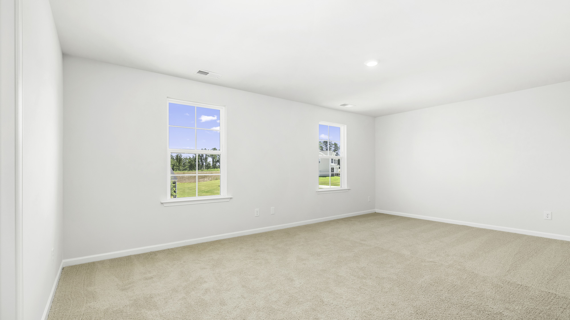bedroom with carpet and 2 two windows