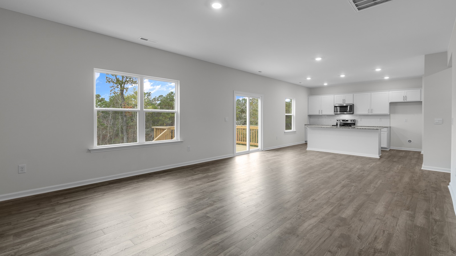 LIVING ROOM WITH PARTIAL KITCHEN VIEW