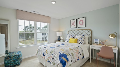 secondary bedroom with double windows and carpet