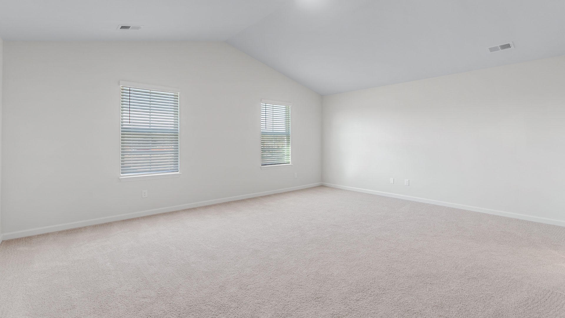 primary bedroom with vaulted cieling