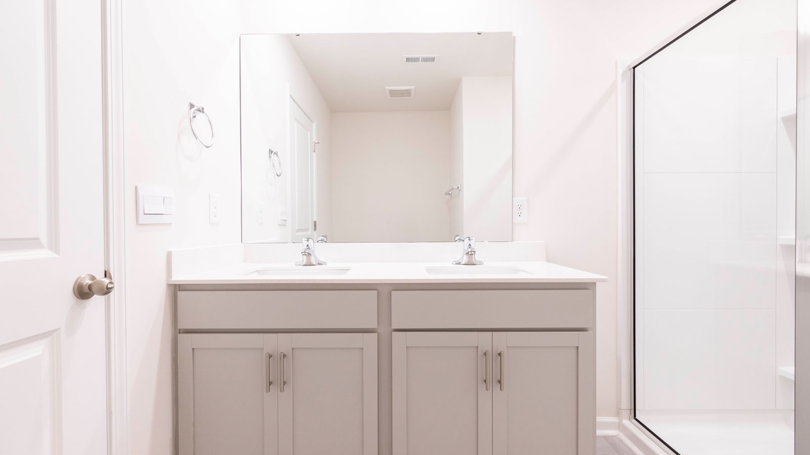 primary bathroom with dual vanities