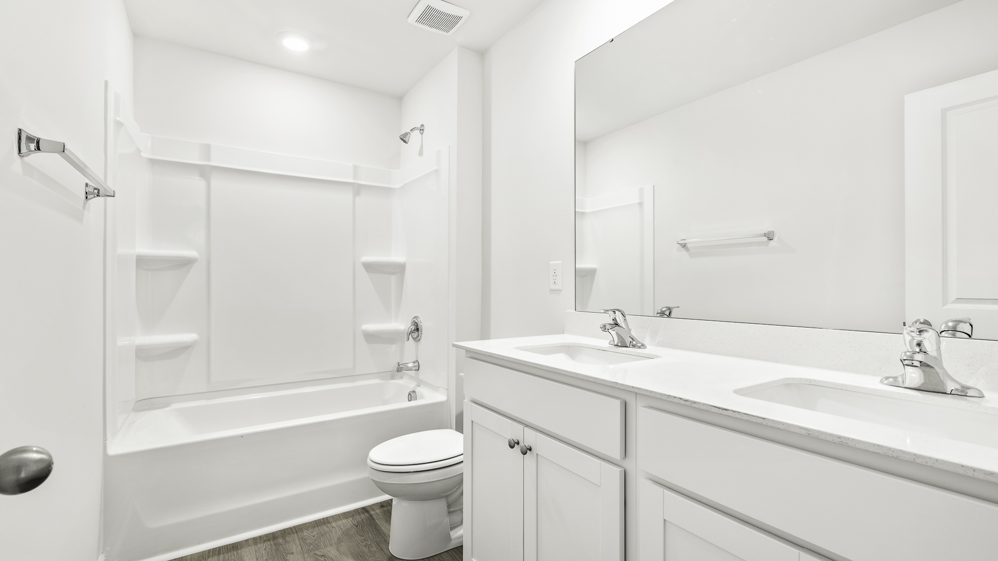 secondary bathroom with tub shower combo and dual sink