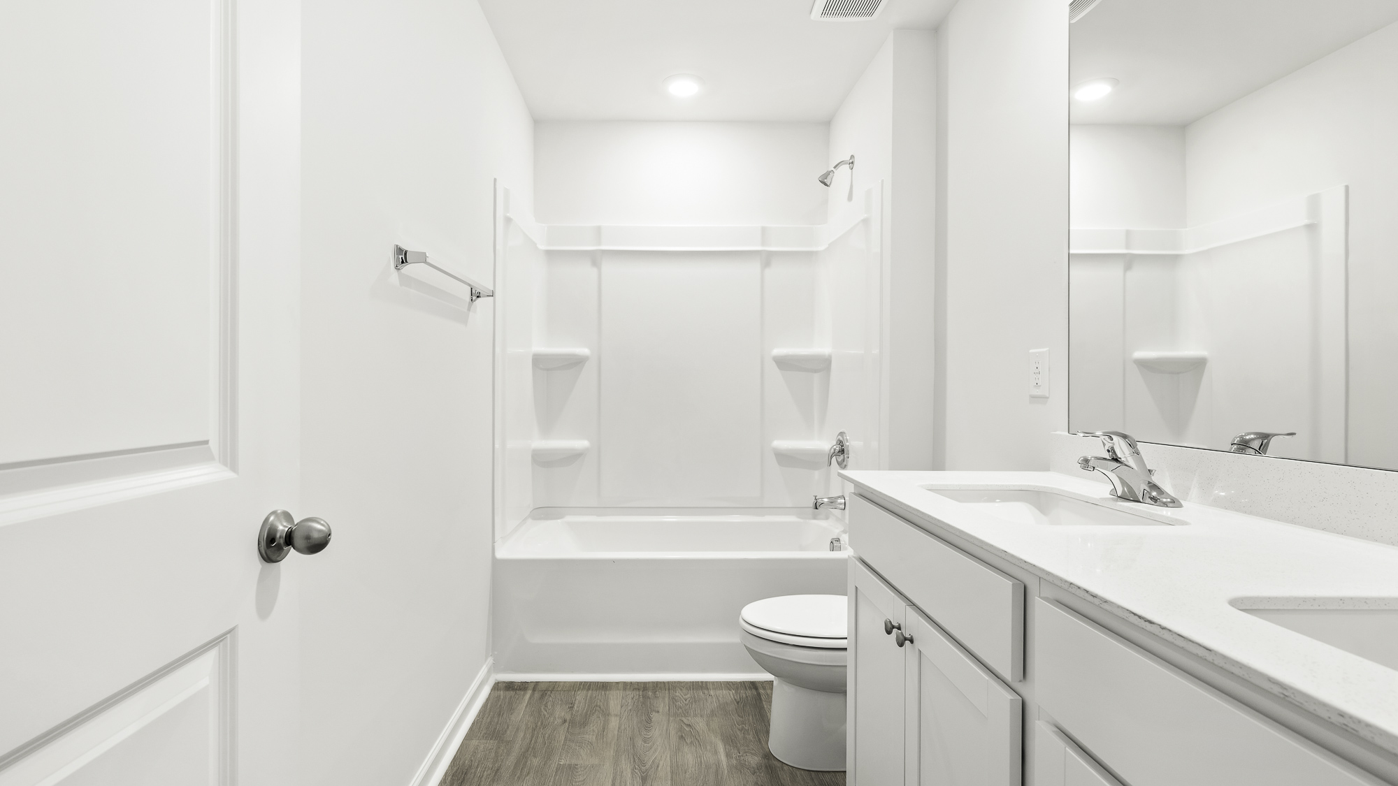 secondary bathroom with tub shower combo and dual sink