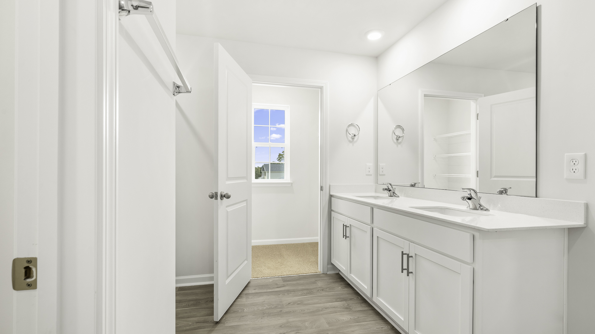 main bathroom with dual sink walk-in closet and walk in shower