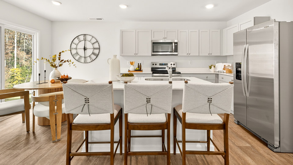 kitchen with gray cabinets stainless steel appliances and quartz countertops