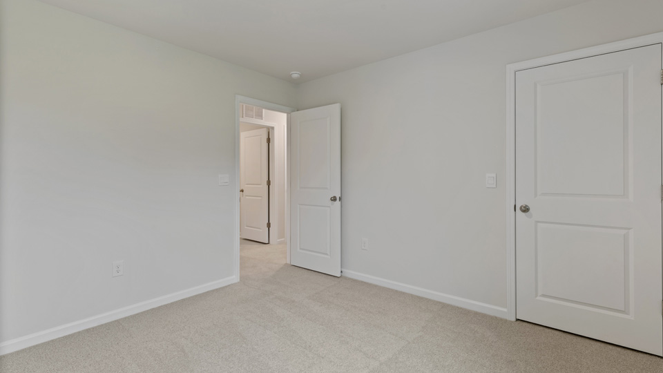 additional bedroom with window, carpeting, closet