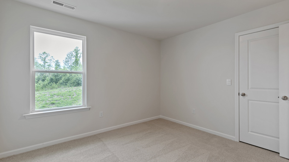 additional bedroom with window, carpeting, closet