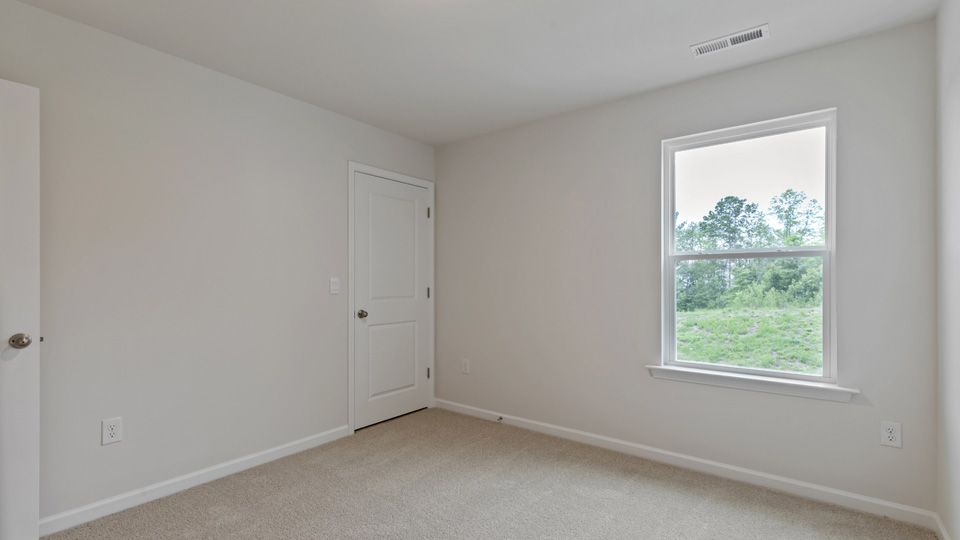 additional bedroom with window, carpeting, closet