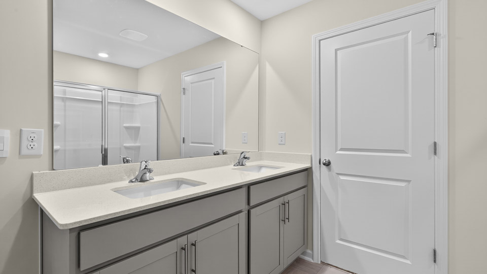 bathroom with quartz countertops and gray cabinets
