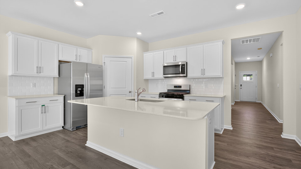 kitchen with white cabinets quartz countertops and stainless steel appliances