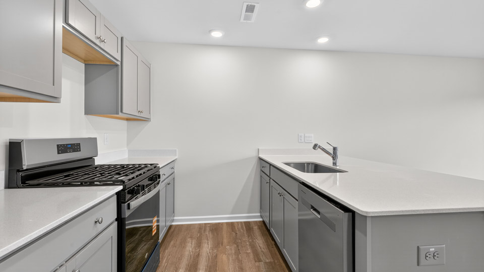 kitchen with gray cabinets and quartz countertops