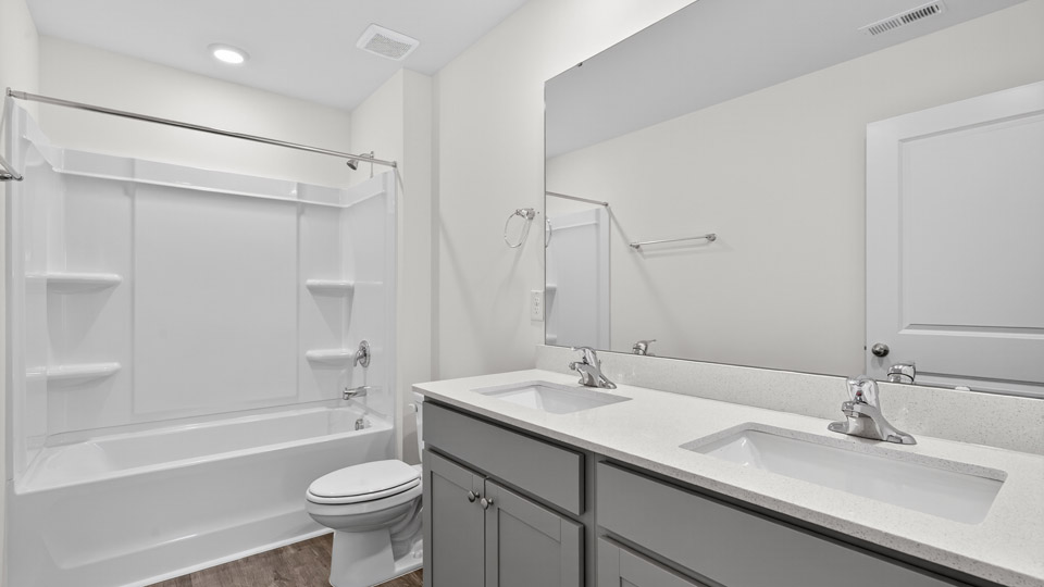 bathroom with tub shower combo and quartz countertops