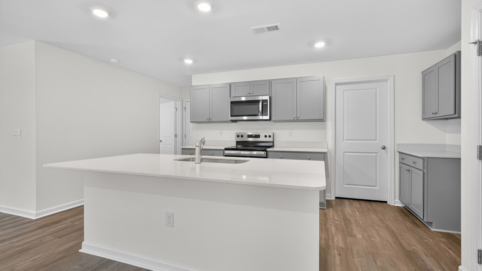 kitchen with gray cabinets quartz coutnertops and stainless steel appliances