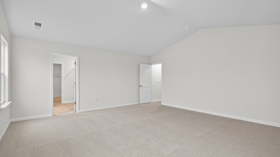 bedroom with vaulted ceiling and carpet flooring
