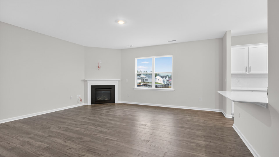 living room with revwood flooring and corner fireplace