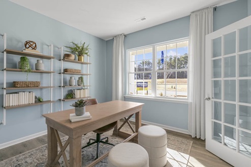 Study with ample lighting and revwood flooring