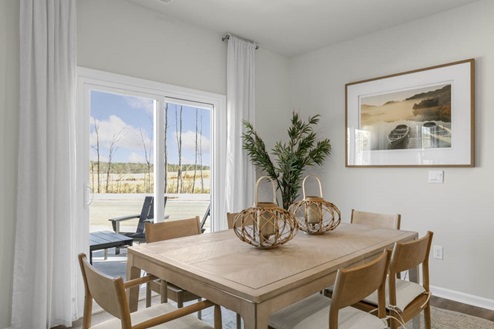 Dining area with ample lighting and revwood flooring
