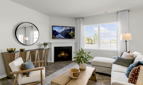 Living area with ample lighting and revwood flooring and gas fireplace