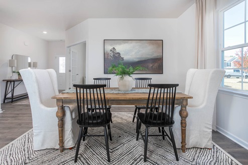 Dining area with natural lighting and revwood flooring