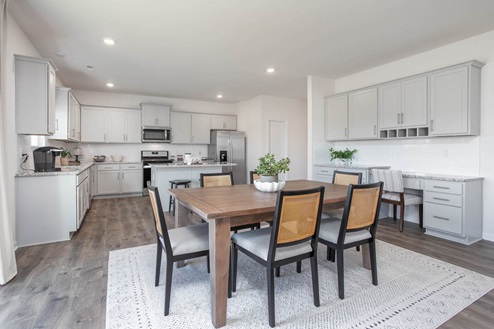 Dining area with natural lighting and revwood flooring