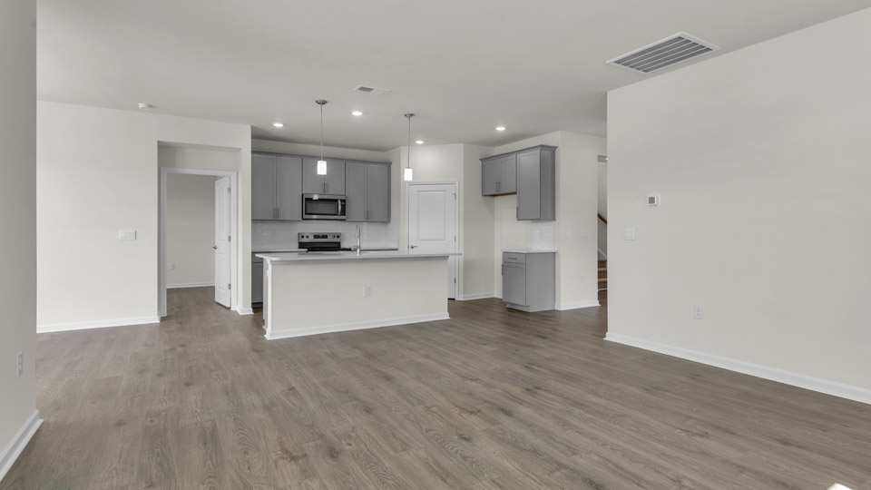 kitchen with quartz countertops overlooking living room
