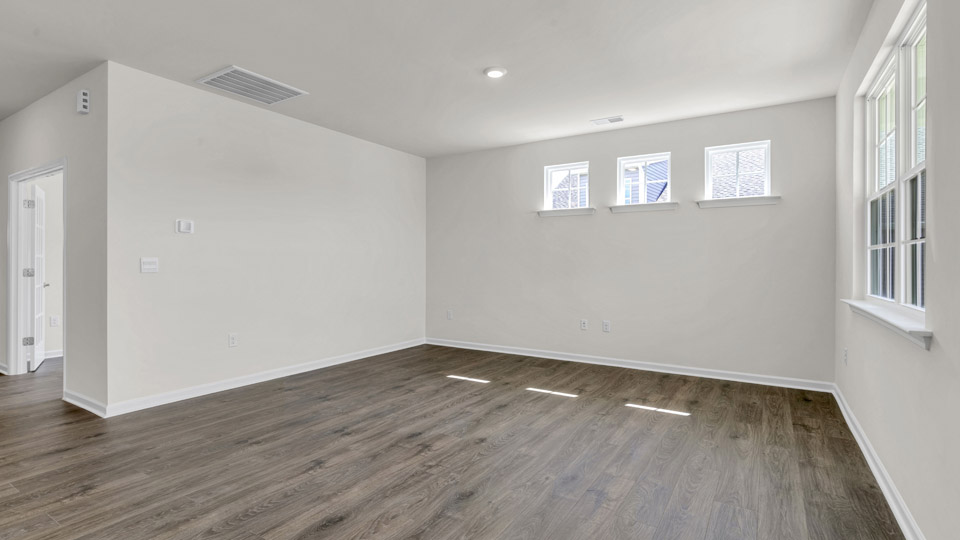 living room with revwood flooring and natural light