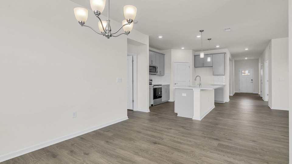 breakfast area next to kitchen with revwood flooring