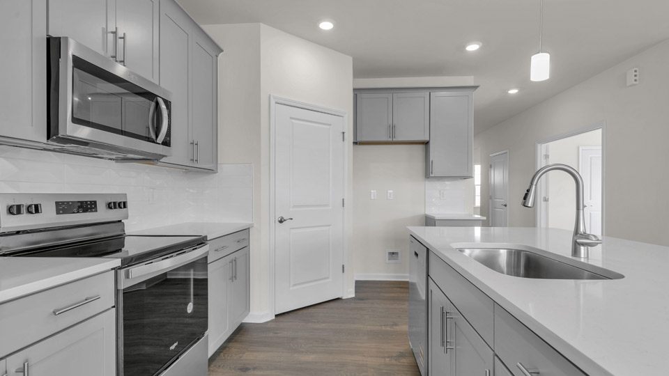 kitchen with gray cabinets and quartz countertops
