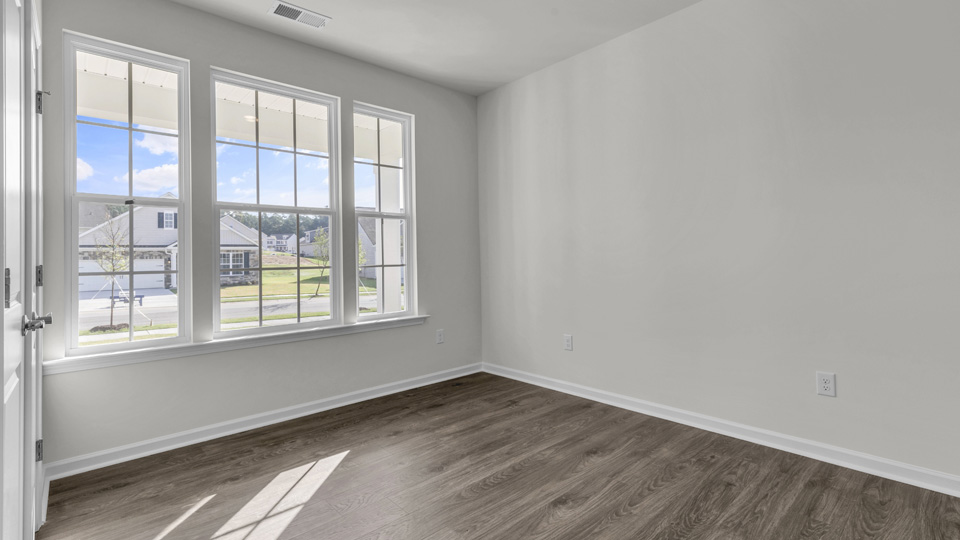 living room with revwood flooring and natural light