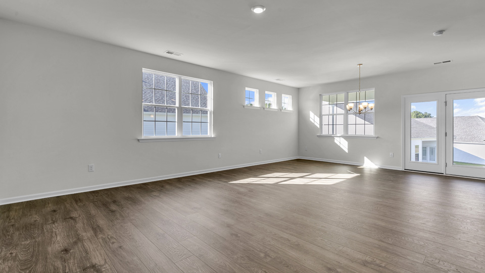 living room with revwood flooring and natural light