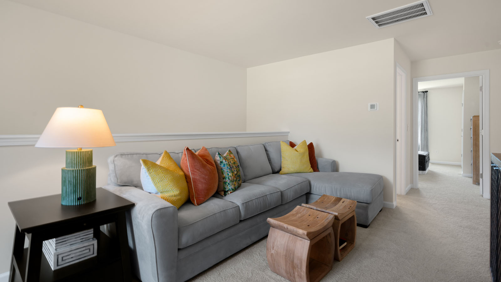 upstairs bonus room with carpet flooring
