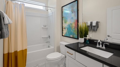 bathroom with revwood flooring and a tub