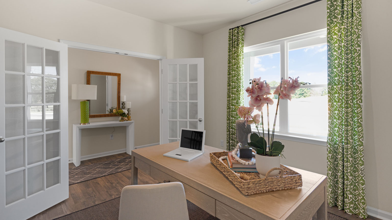 study with ample lighting and revwood flooring and french doors