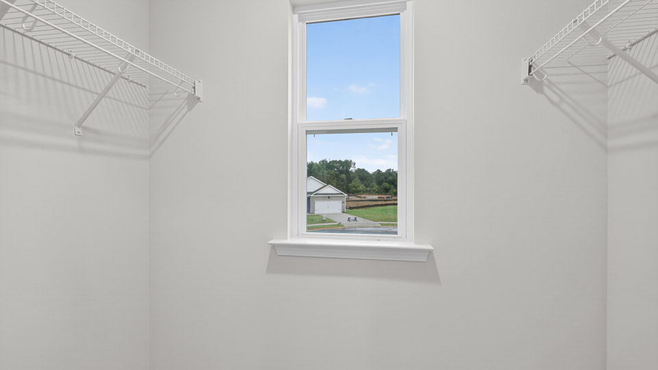 bathroom walk-in closet with wire shelvingwith quartz countertops