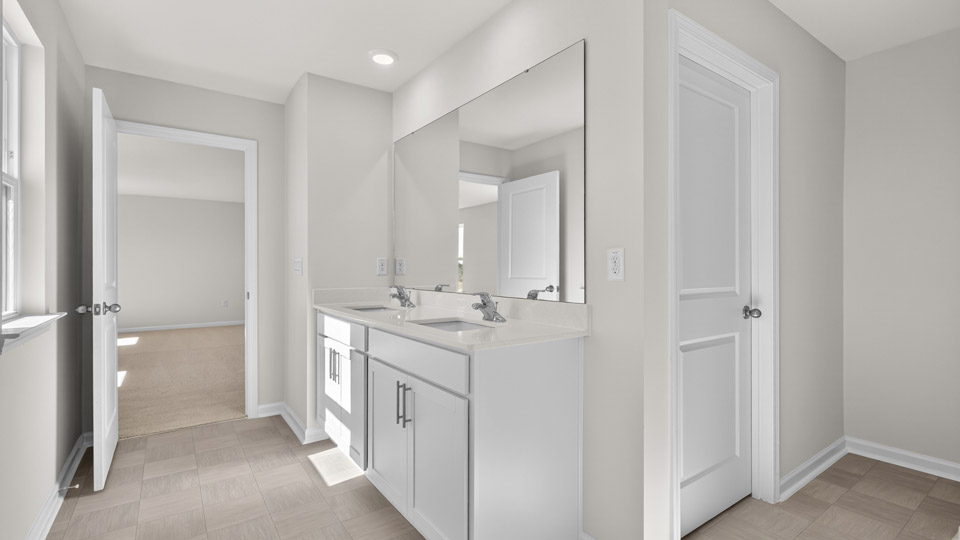 bathroom with quartz countertops and separate sinks