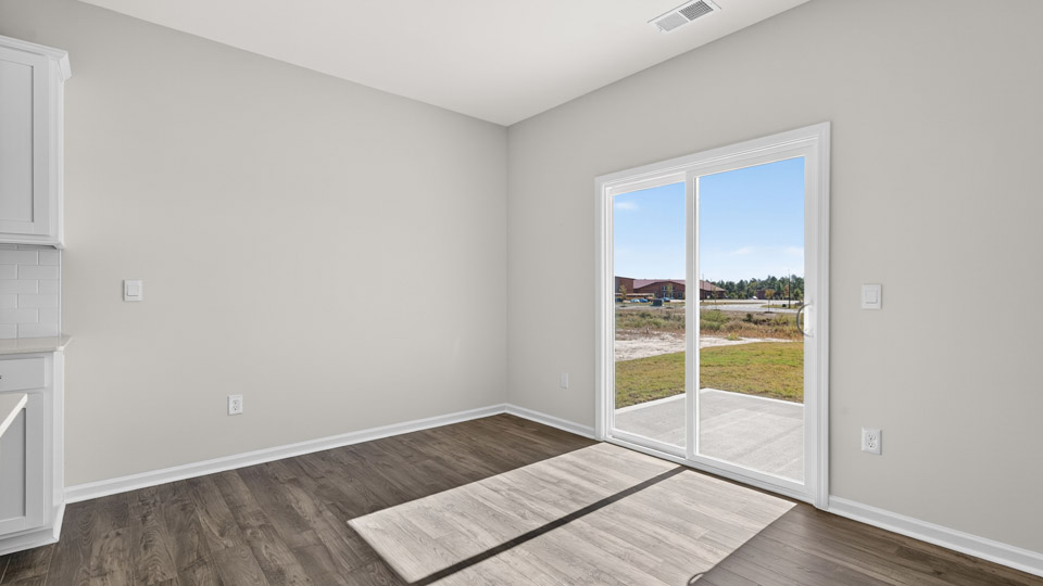 breakfast area with sliding glass doors and revwood flooring