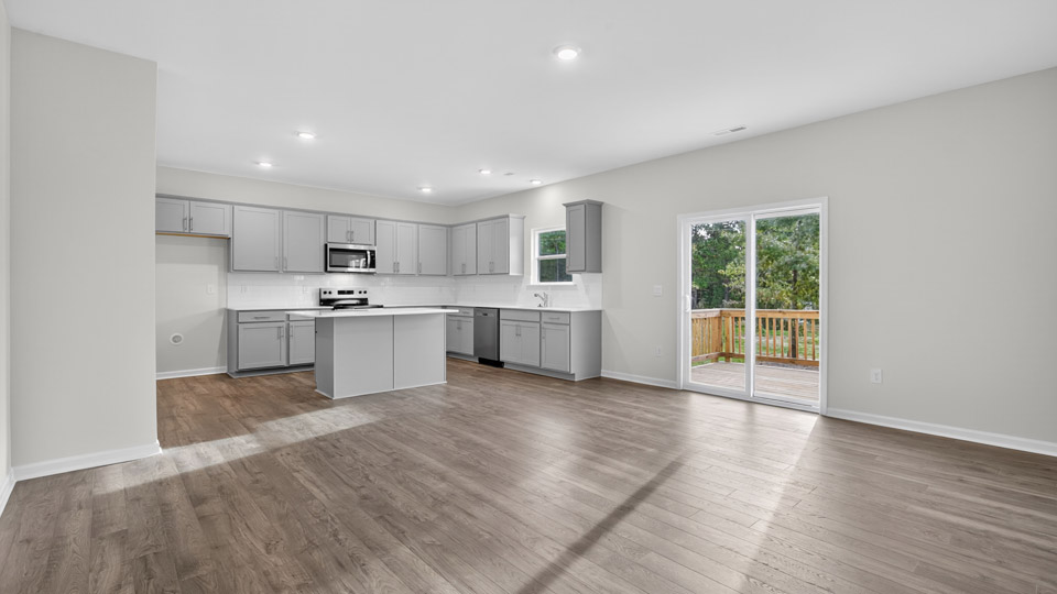 dining area overlooked by kitchen and sliding glass doors