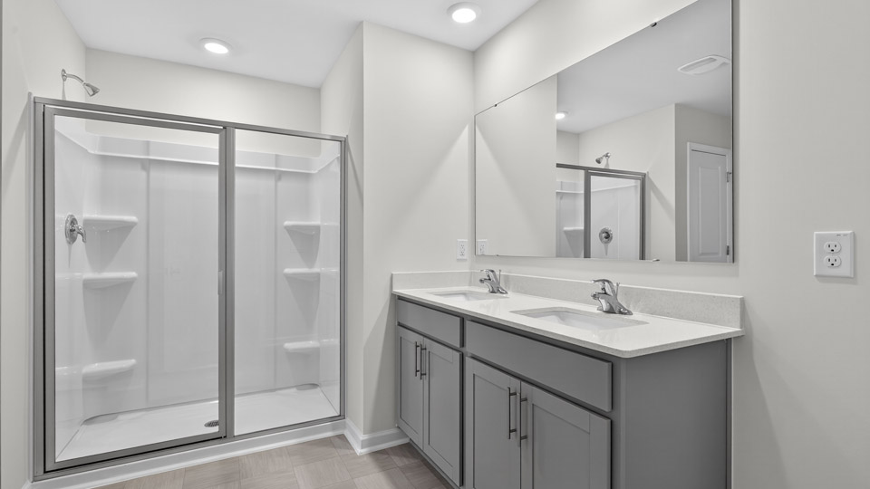 bathroom with gray cabinets and quartz countertops