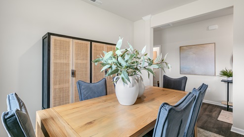 Formal dining area with ample lighting and revwood flooring