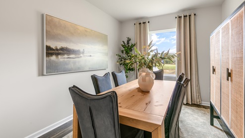 Formal dining area with ample lighting and revwood flooring
