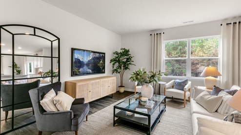Living area with ample lighting and revwood flooring
