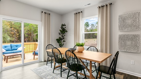 Dining area with ample lighting and revwood flooring