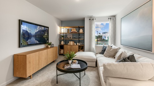 Loft with natural lighting and carpet flooring