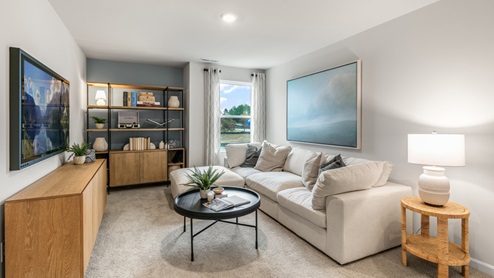 Loft with natural lighting and carpet flooring