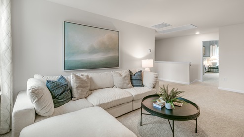 Loft with natural lighting and carpet flooring