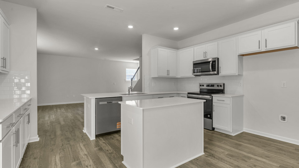 Kitchen with quartz countertops and stainless steel appliances
