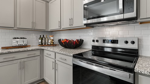 Kitchen with revwood flooring, and island, open floorplan and stainless style cabinets
