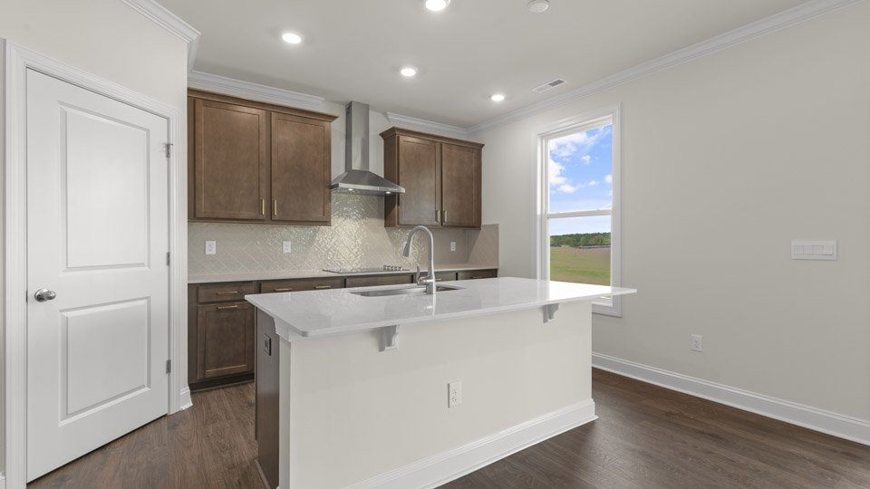 kitchen with brown cabinets and quartz countertops